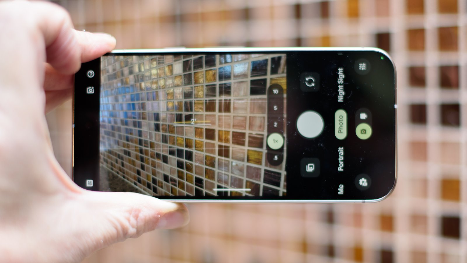 Google Pixel 10 Pro in Jade with checkered tile backsplash background