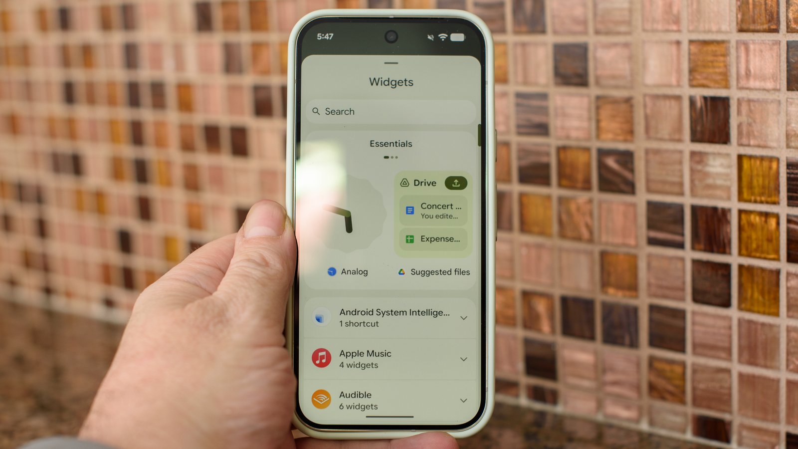 Google Pixel 10 Pro in Jade with checkered tile backsplash background